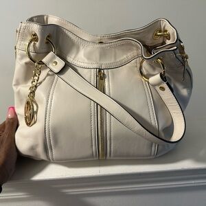 Soft leather Michael Kors handbag with gold hardware.